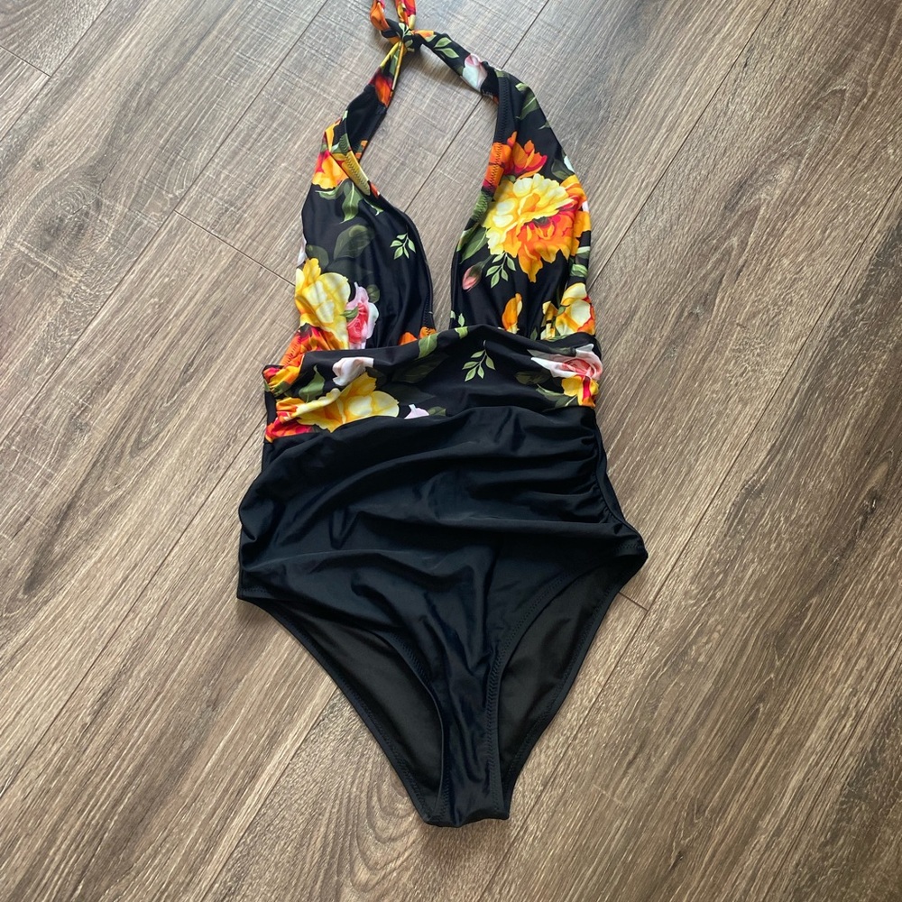Bathing suit with halter and floral/black print. New without tags.